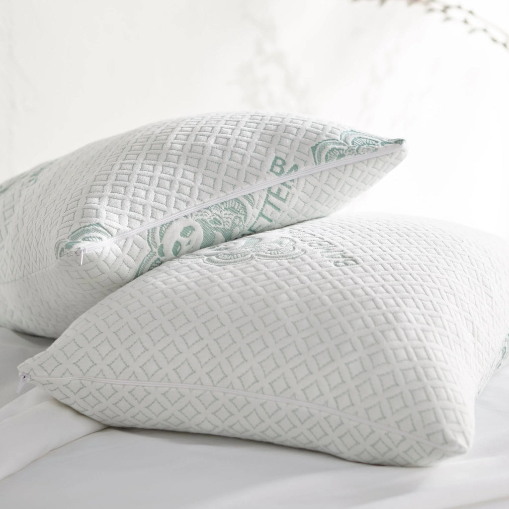 Adjustable bamboo cooling pillows styled on a white bed